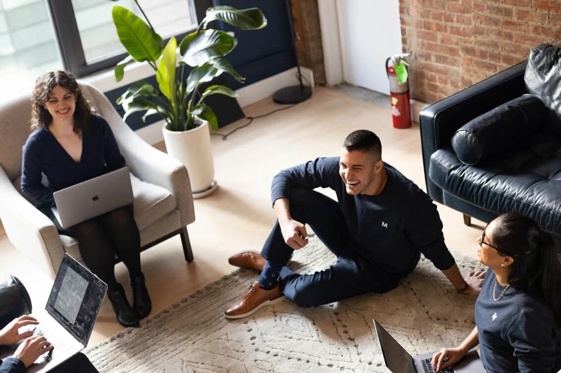 Four MANTL employees laughing and working together.